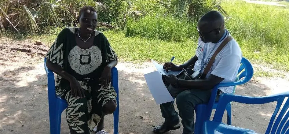 A community member shares her views with an enumerator during the baseline survey.