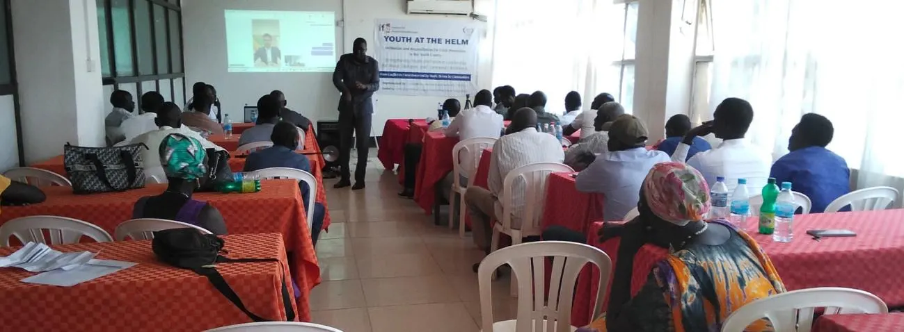 Government representatives and community leaders discussing youth participation in peacebuilding.
